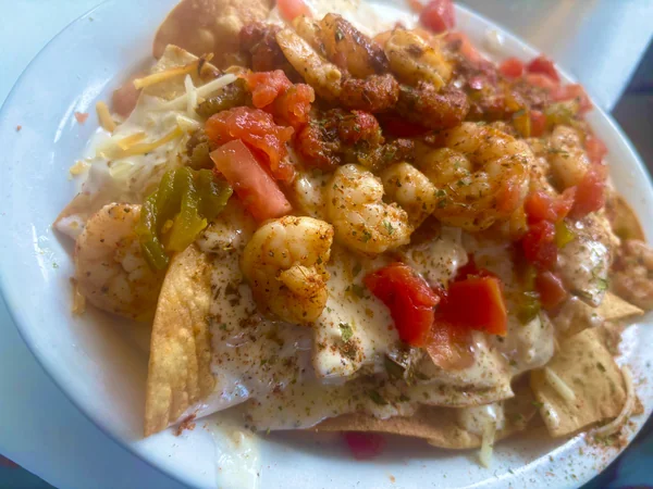 Seafood Nachos at Chef Charles Bistreaux: fried chips piled with seasoned Louisiana shrimp, cheese sauce, diced tomato, and peppers