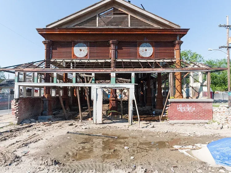 St. Roch Market New Orleans devastated after Hurricane Katrina in 2005, showing exposed framing and debris on St. Claude Avenue