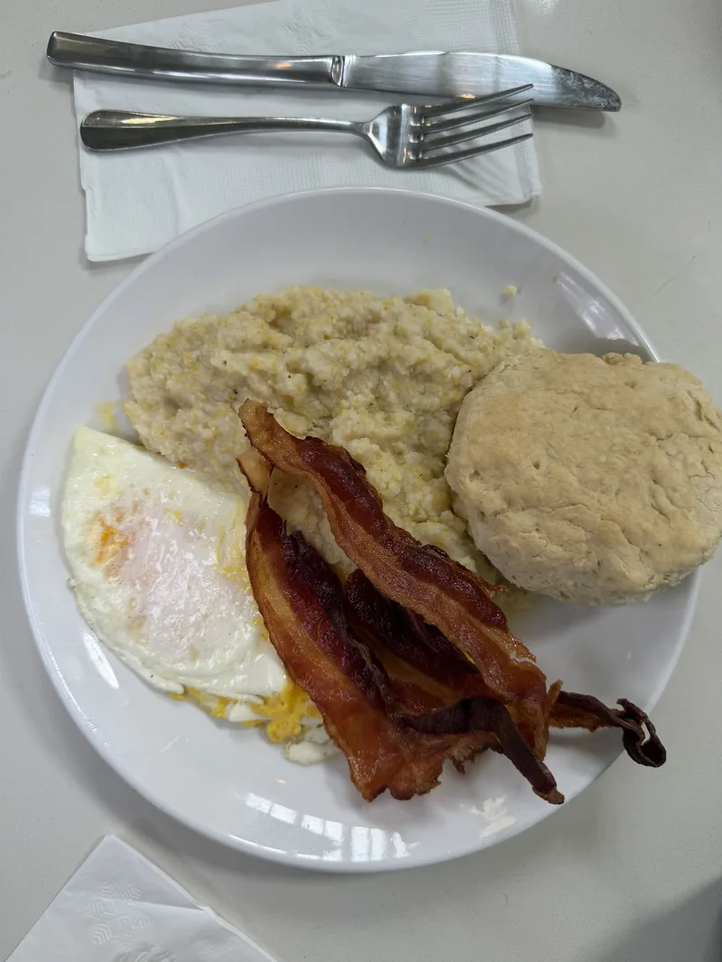 The Eye Opener at Chef Charles Bistreaux: eggs over easy, bacon, creamy grits, and a biscuit