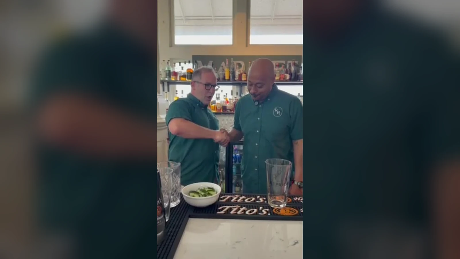 Sean 'Doeboy' Verrett and Kevin Pedeaux behind the bar at Roch's Reprieve inside St. Roch Market, cucumber and pint glasses ready on the Tito's bar mat